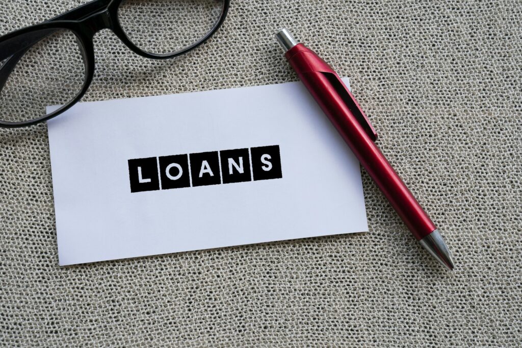 The word LOAN on white paper with a red pen